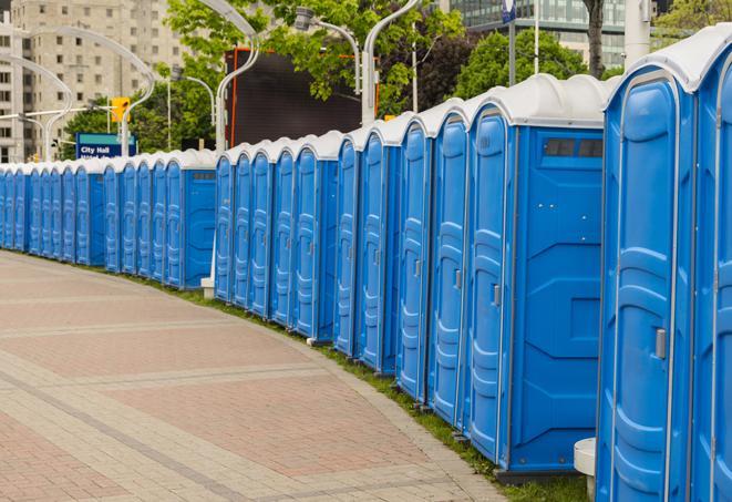 a row of portable restrooms at an outdoor special event, ready for use in Groom, TX